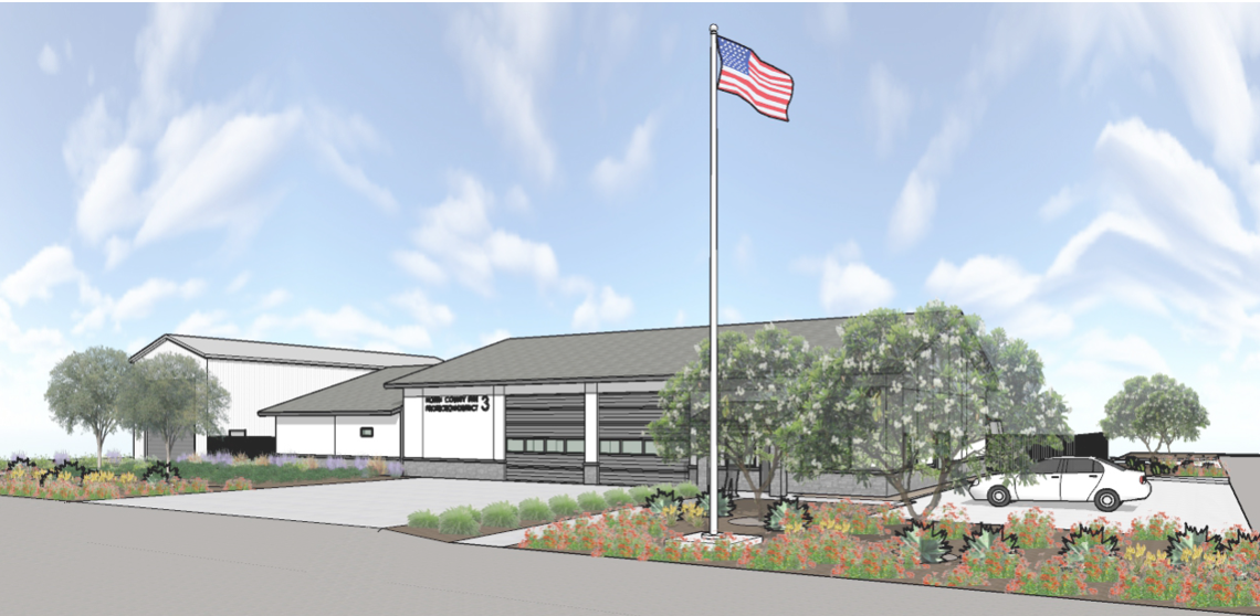 A building with a U.S. flag, trees, flowers, and a parked car on a sunny day.