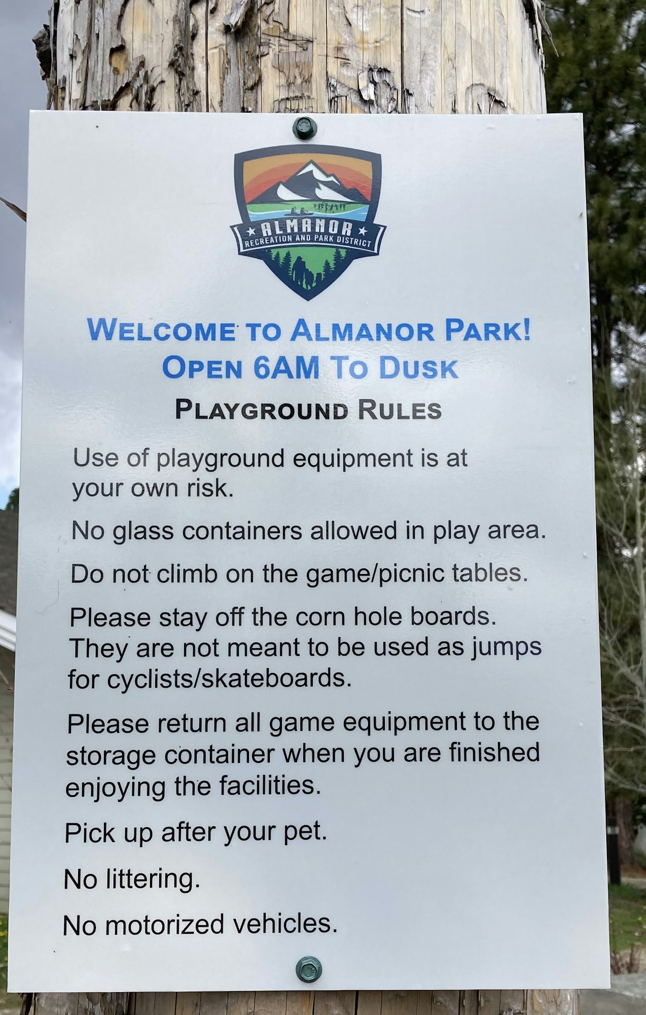 Sign with rules for Almanor Park: no glass, climb, littering, motorized vehicles; clean up after pets; use equipment responsibly.