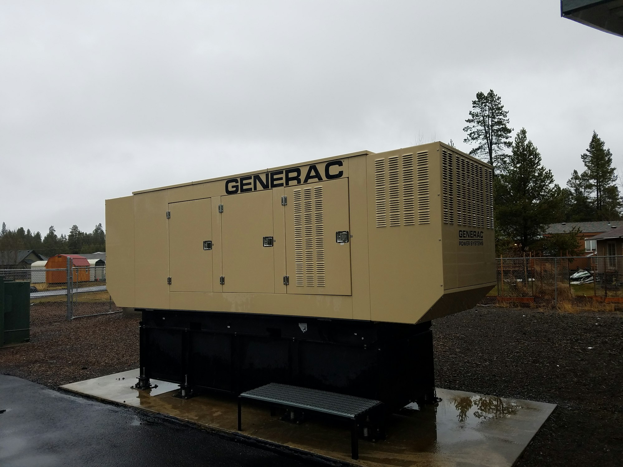 A large Generac power generator outside on a cloudy day.