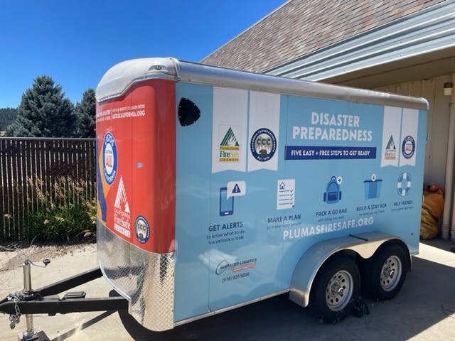 Disaster preparedness trailer with info on alerts, planning, and kits. Website and sponsorship logos visible.