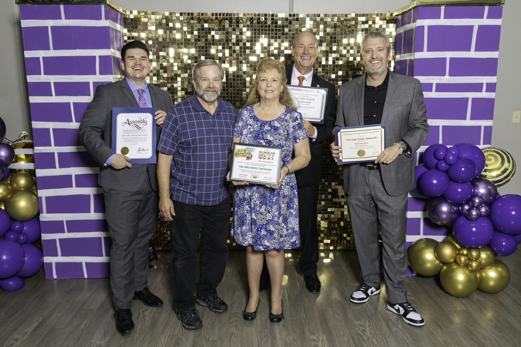 May contain: clothing, footwear, shoe, adult, male, man, person, female, woman, people, purple, accessories, formal wear, tie, groupshot, bracelet, jewelry, balloon, and wristwatch