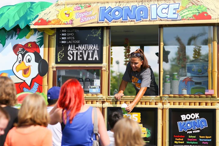 Tropical shaved ice truck serving a crowd, featuring all-natural stevia sweetener and promoting no gluten, GMO, HFCS, or lactose.