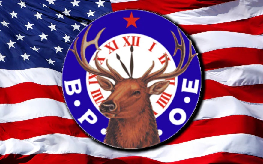 An American flag with a circular emblem of an elk with antlers, surrounded by "B.P.O.E." and a red star.