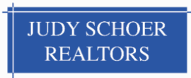 Blue sign with white text: "JUDY SCHOER REALTORS".
