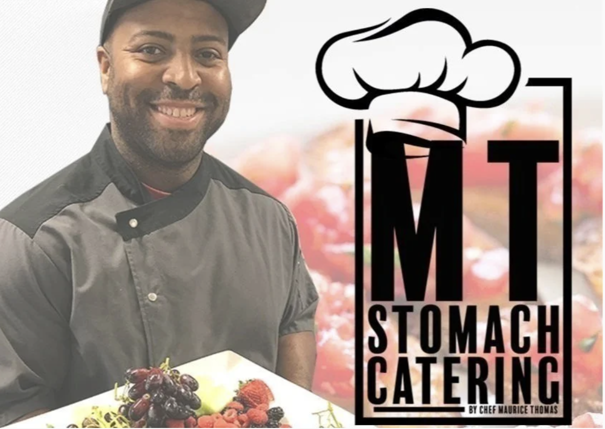 A smiling chef in a black and gray uniform presents a plate of fruit, alongside the logo for "MT Stomach Catering."
