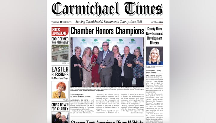 Newspaper front page headline: "Chamber Honors Champions." Features a group photo, articles on economic development, Easter, and other local news.