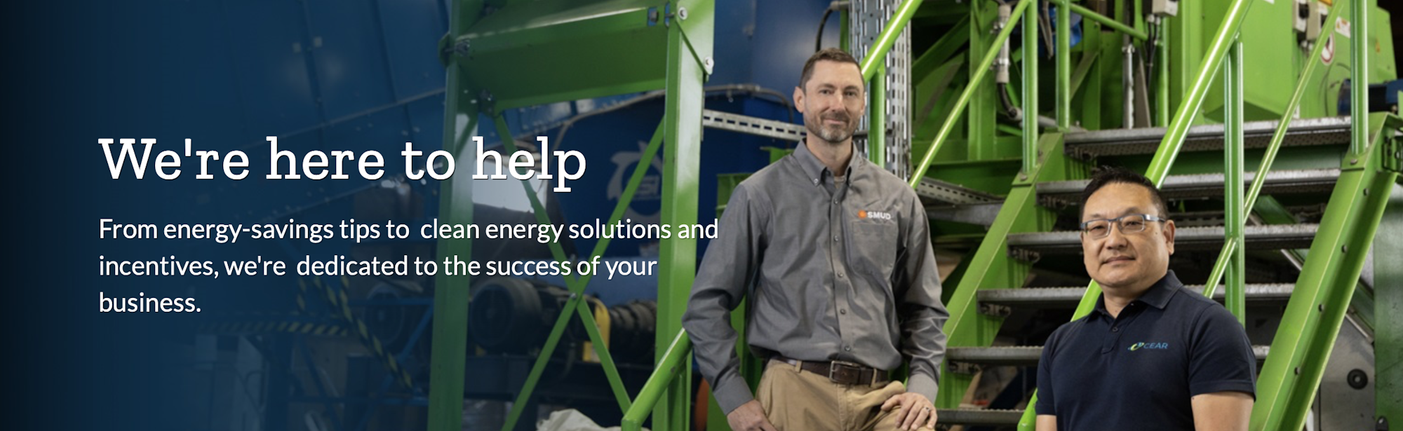 Two people in front of industrial equipment with text: "We're here to help" about energy savings and clean energy solutions.