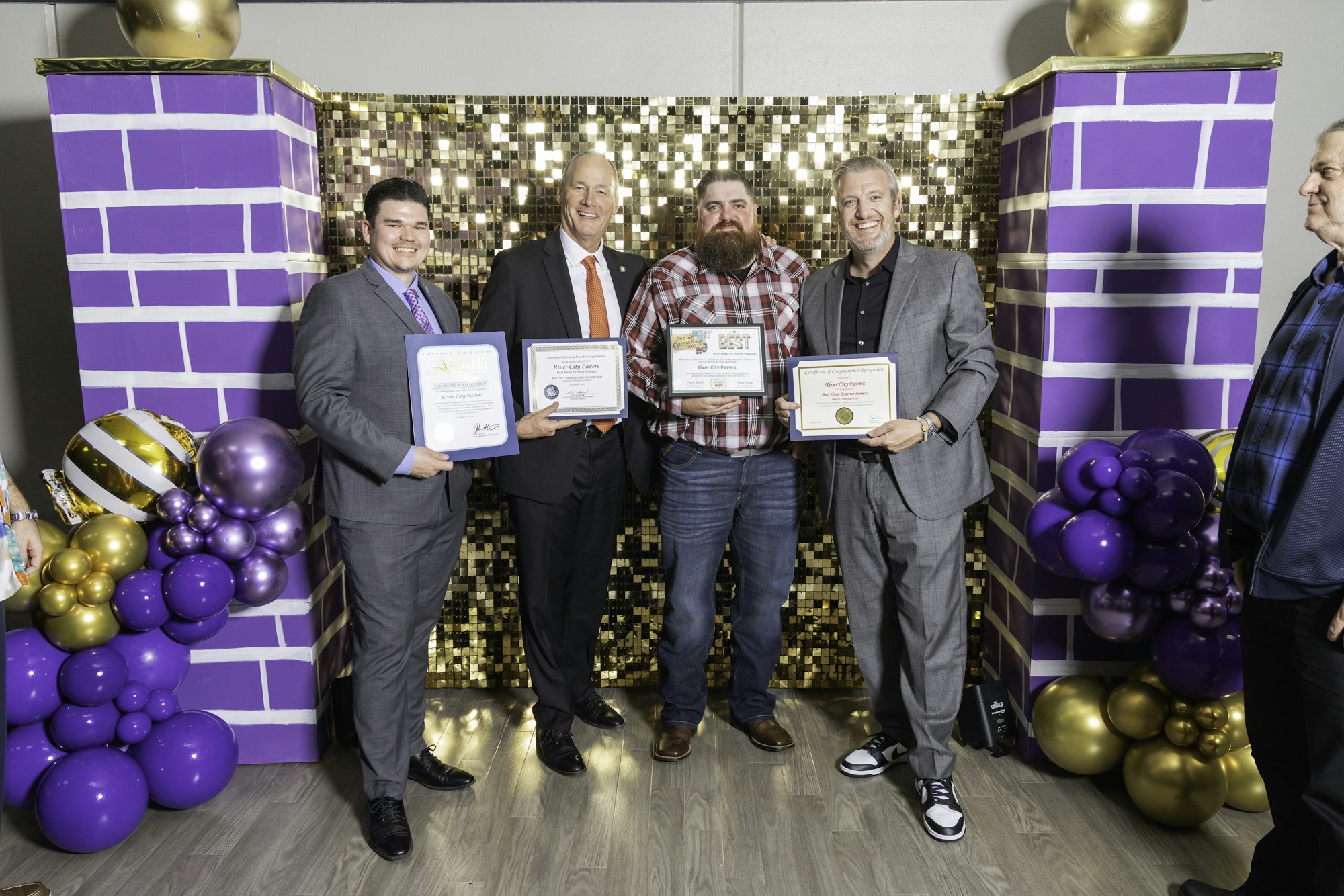 May contain: people, person, clothing, footwear, shoe, adult, male, man, purple, accessories, formal wear, tie, groupshot, balloon, helmet, and wristwatch