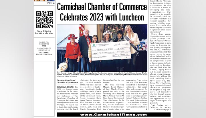 A group celebrates with a large check during the Carmichael Chamber of Commerce 2023 luncheon.