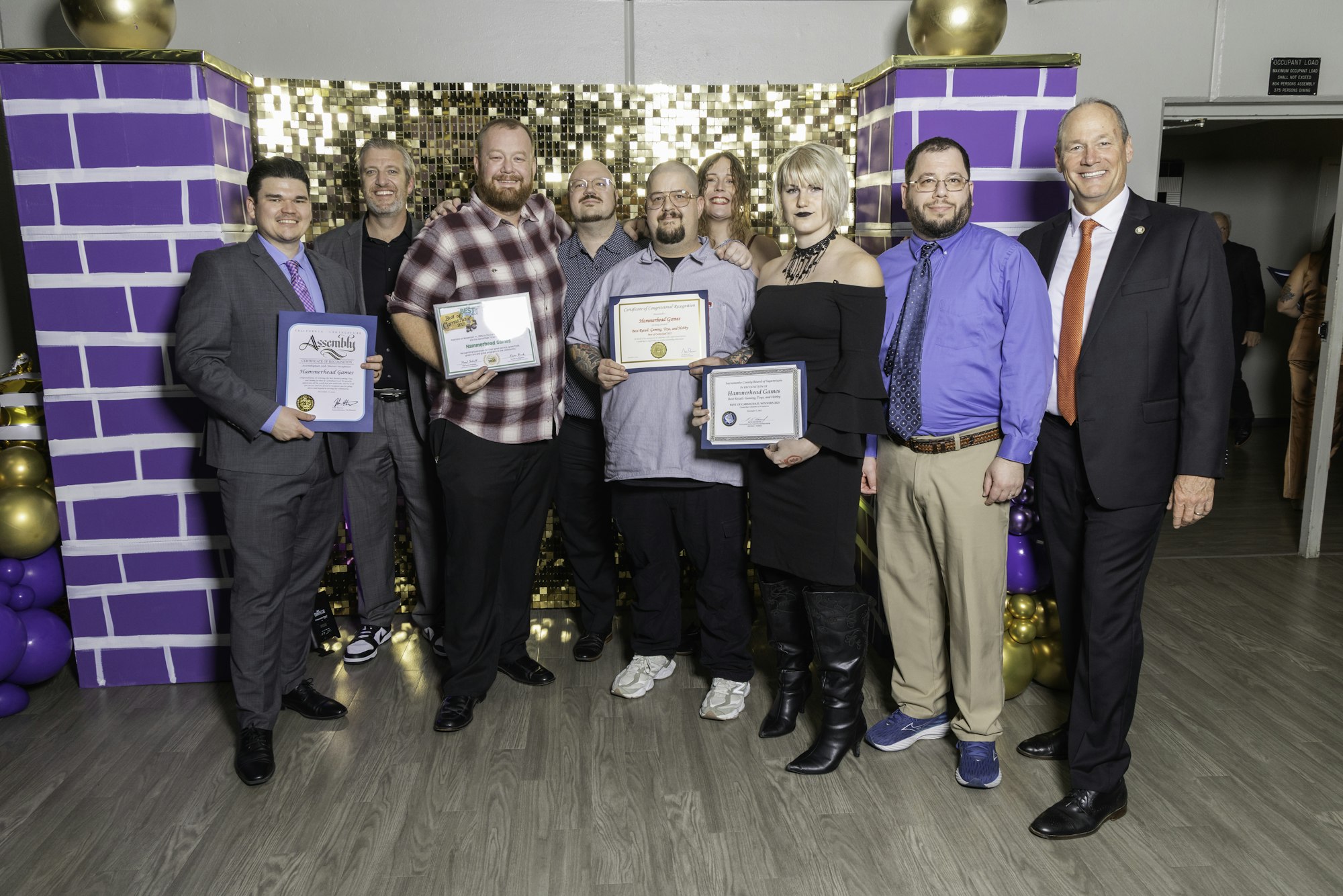 May contain: groupshot, person, clothing, footwear, shoe, people, accessories, formal wear, tie, adult, male, man, glasses, jewelry, necklace, and belt