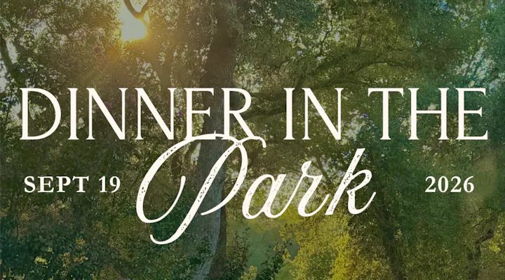 The image features a promotional text for "Dinner in the Park" scheduled for September 19, 2026, surrounded by greenery.
