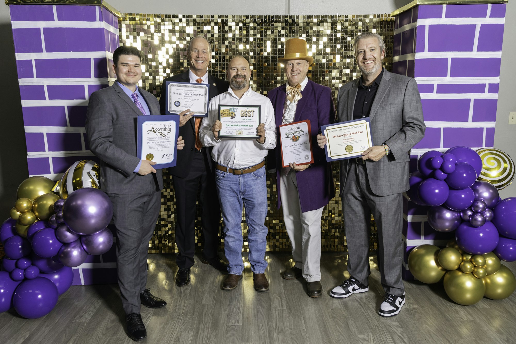 May contain: purple, people, person, clothing, footwear, shoe, adult, male, man, groupshot, accessories, formal wear, tie, sphere, hat, balloon, wristwatch, and belt