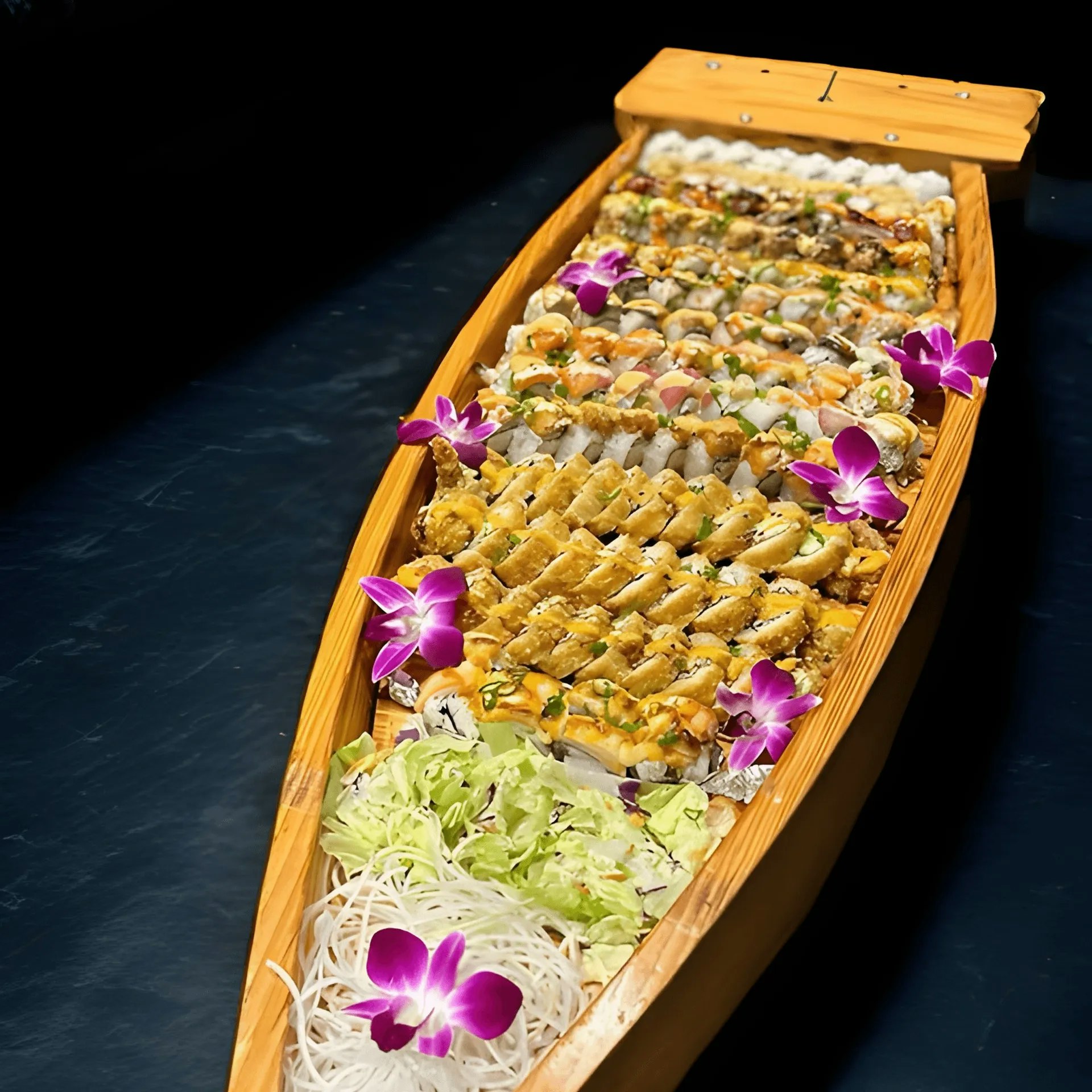A wooden sushi boat with assorted sushi rolls and purple flowers for garnish.