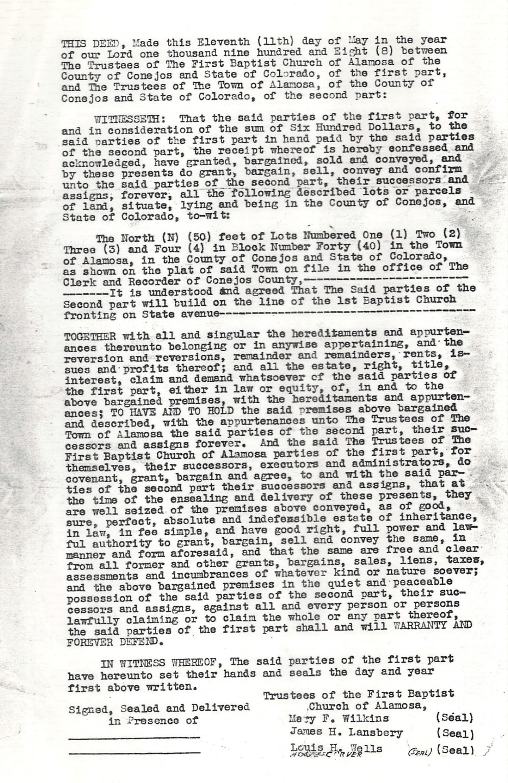 A deed document from May 11, 1908, transferring land in Alamosa, Colorado from the First Baptist Church to the town trustees.