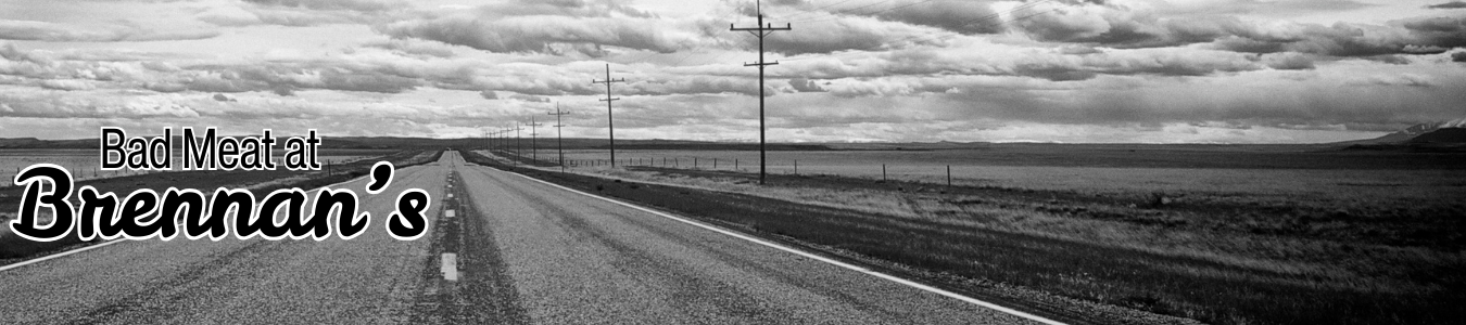 A black-and-white image of an empty road under a cloudy sky with the text "Bad Meat at Brennan's."