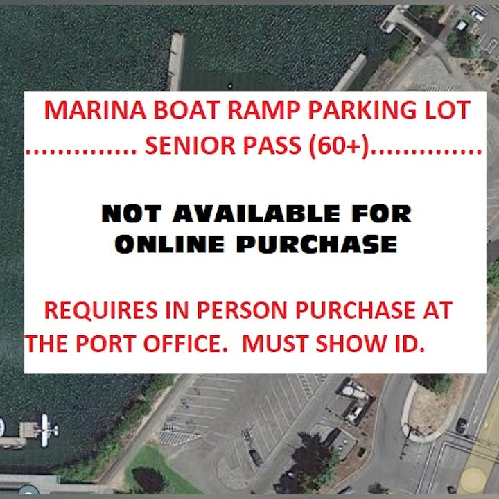 Aerial view of a boat ramp parking lot with text overlay stating Marina Boat Ramp Parking Lot Senior Pass (60+) Not Available For Online Purchase. Requires In Person Purchase At The Port Office. Must Show ID.