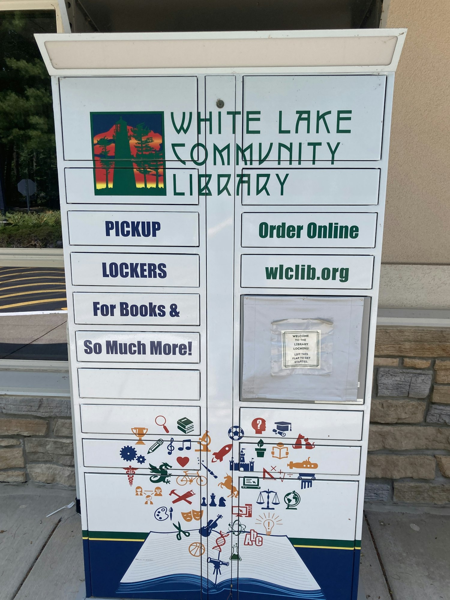 Library pickup lockers with instructions and a colorful design at White Lake Community Library.