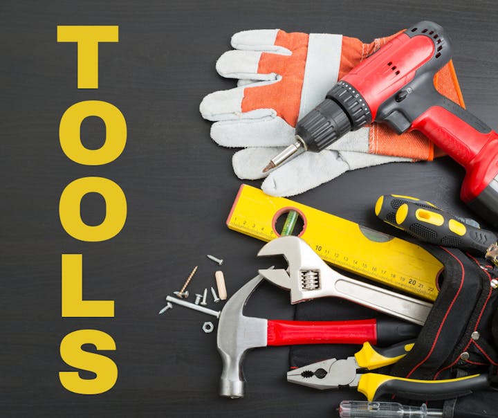 Assorted tools, including a drill, hammer, screwdriver, pliers, and gloves, on a dark surface with the word "TOOLS".