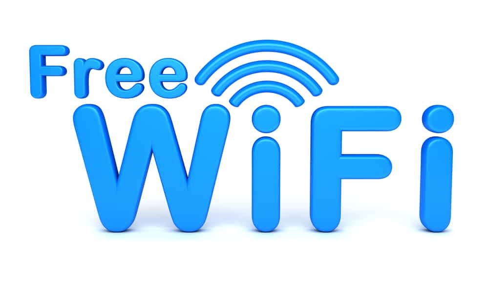 The image shows a blue "Free WiFi" sign with a wireless signal symbol above the "i".