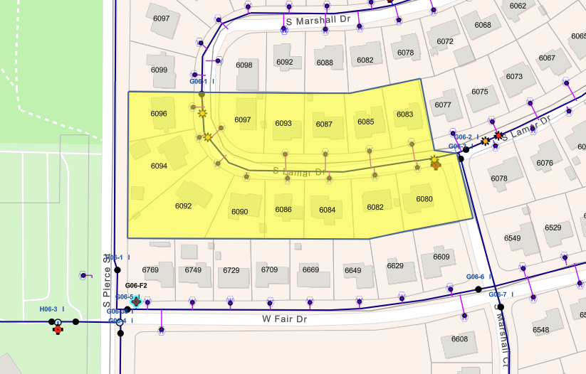 The image shows a map with highlighted residential areas, streets, and utility points in a neighborhood layout.