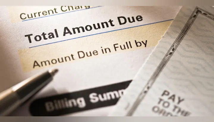 The image shows a billing statement with a focus on the "Total Amount Due" and a check for payment.