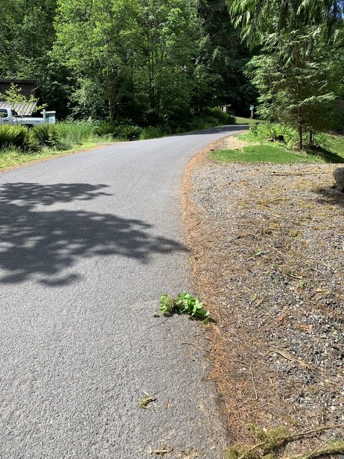 May contain: road, outdoors, architecture, building, housing, aerial view, house, driveway, and tarmac