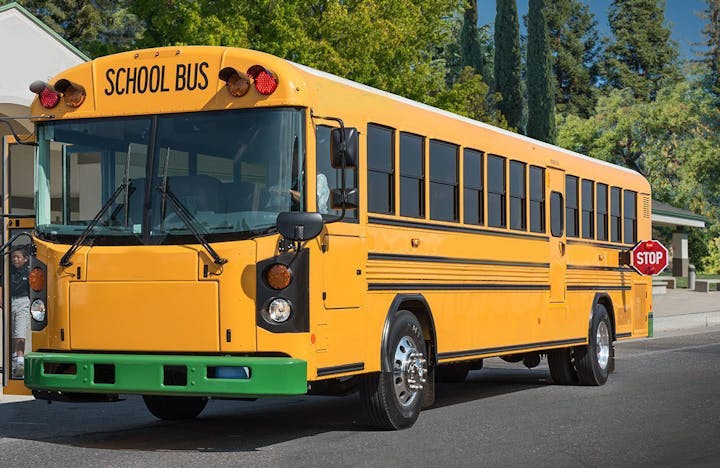 May contain: vehicle, transportation, bus, person, human, and school bus