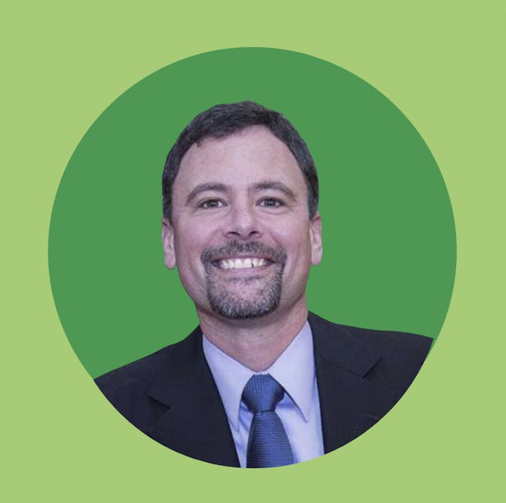 May contain: accessories, formal wear, tie, face, head, person, photography, portrait, clothing, suit, adult, male, man, blazer, coat, jacket, happy, smile, body part, mouth, and teeth