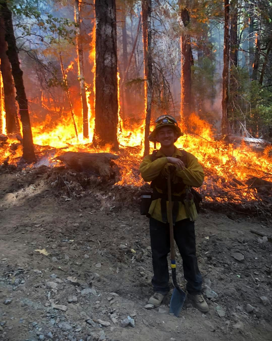 May contain: person, human, fire, forest fire, shoe, clothing, footwear, and apparel