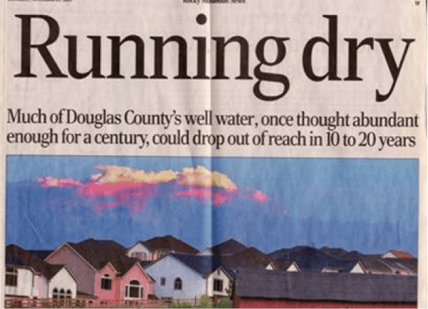 Newspaper headline about Douglas County's well water scarcity, with houses and mountains pictured below.