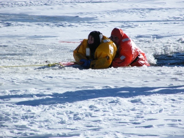 May contain: clothing, lifejacket, vest, coat, glove, person, outdoors, and nature