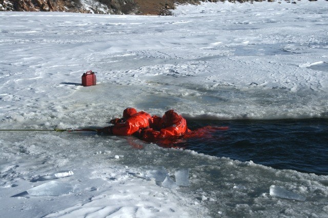 May contain: clothing, lifejacket, vest, mountain, nature, outdoors, ice, transportation, vehicle, watercraft, and person