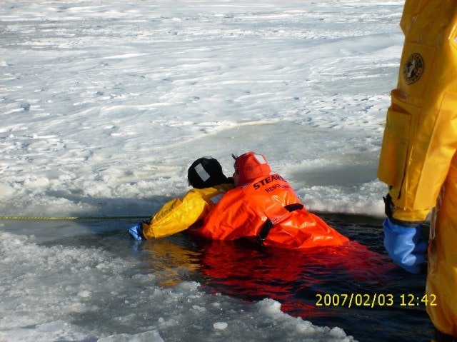 May contain: clothing, coat, lifejacket, vest, person, footwear, and shoe