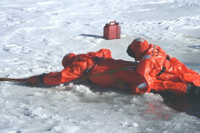 May contain: clothing, coat, lifejacket, vest, jacket, person, and ice