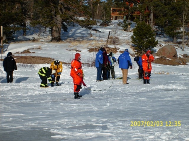 May contain: clothing, lifejacket, vest, person, glove, helmet, hat, coat, nature, outdoors, piste, snow, and sport