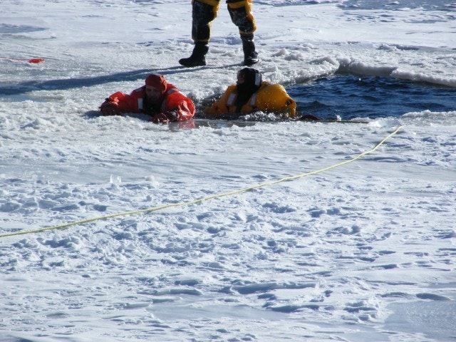May contain: clothing, lifejacket, vest, person, adult, female, woman, footwear, shoe, outdoors, helmet, and nature