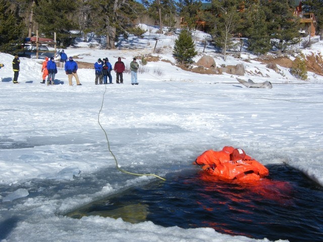 May contain: clothing, lifejacket, vest, person, helmet, outdoors, and water