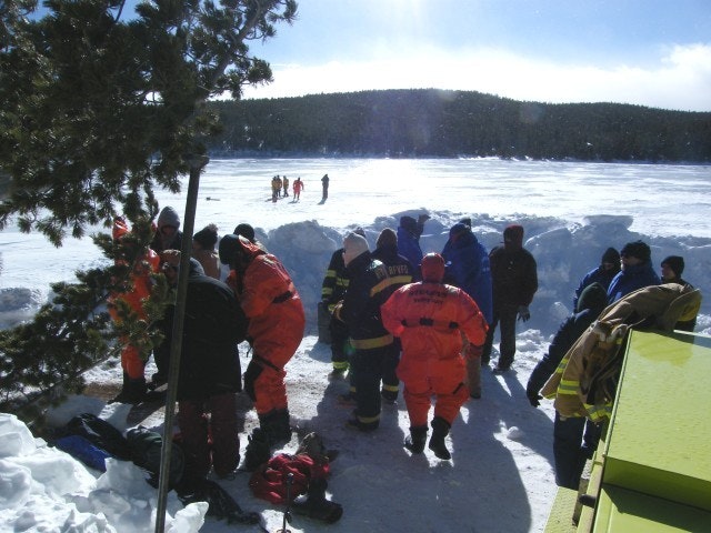May contain: clothing, glove, lifejacket, vest, adult, male, man, person, footwear, shoe, nature, outdoors, coat, and hat
