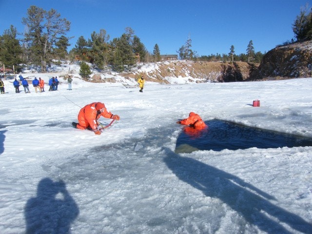 May contain: clothing, lifejacket, vest, person, glove, transportation, vehicle, watercraft, nature, outdoors, scenery, and ice