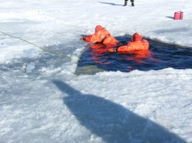 May contain: clothing, lifejacket, vest, mountain, nature, outdoors, transportation, vehicle, watercraft, ice, and person