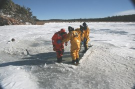 May contain: clothing, lifejacket, vest, person, outdoors, nature, ice, transportation, vehicle, and watercraft