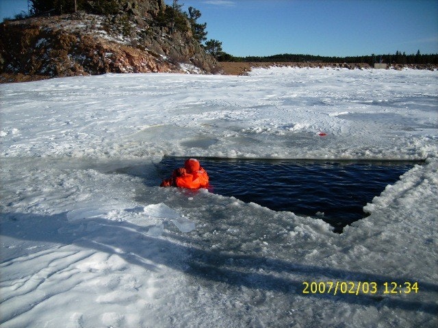 May contain: clothing, lifejacket, vest, person, helmet, ice, water, nature, outdoors, and mountain