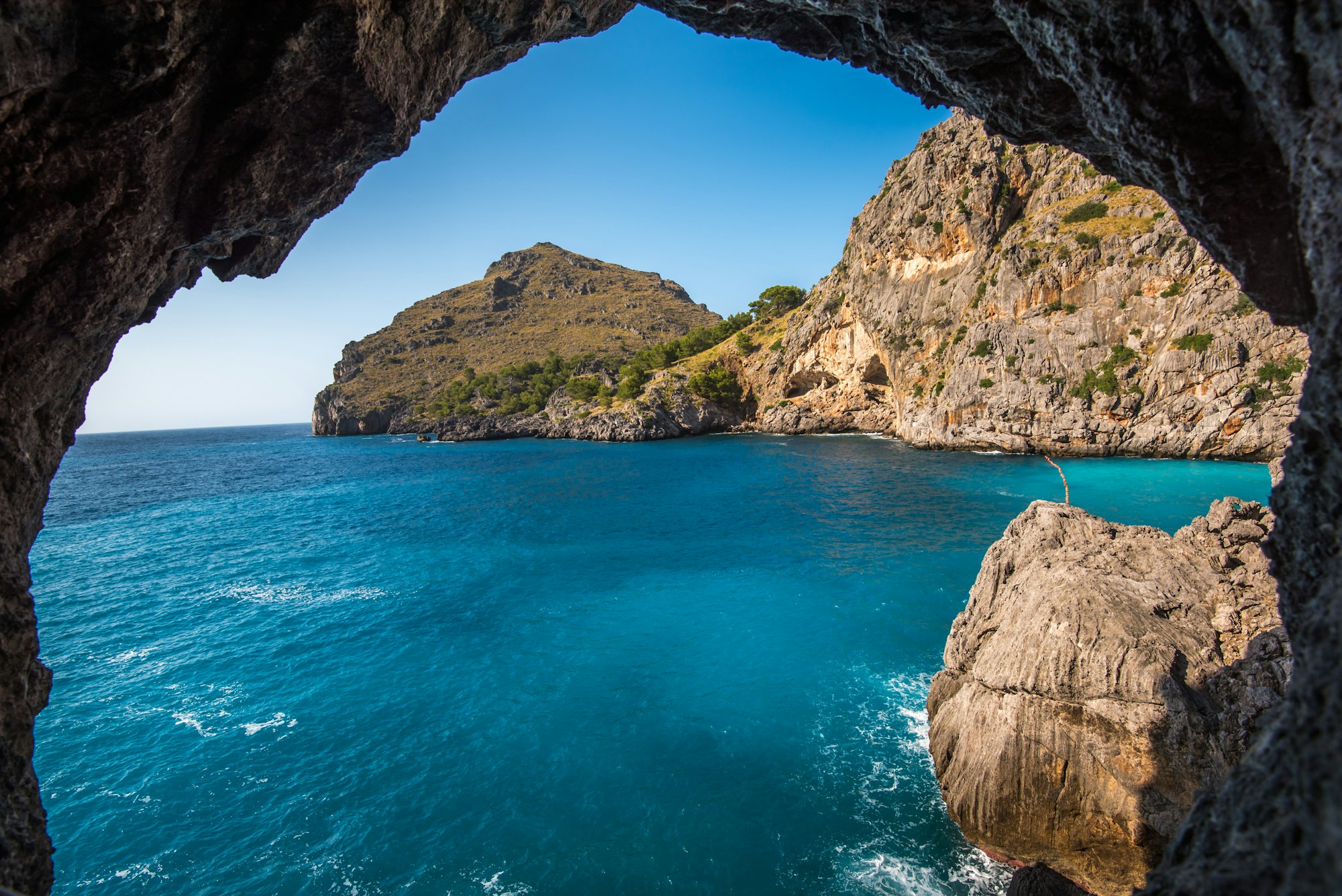 May contain: cave, coast, cove, nature, outdoors, sea, shoreline, water, promontory, land, and person