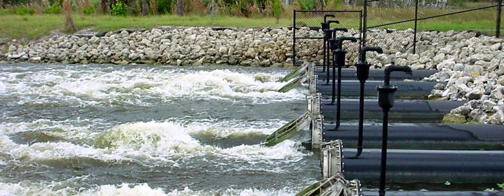 Stormwater pumps discharging water into a canal.