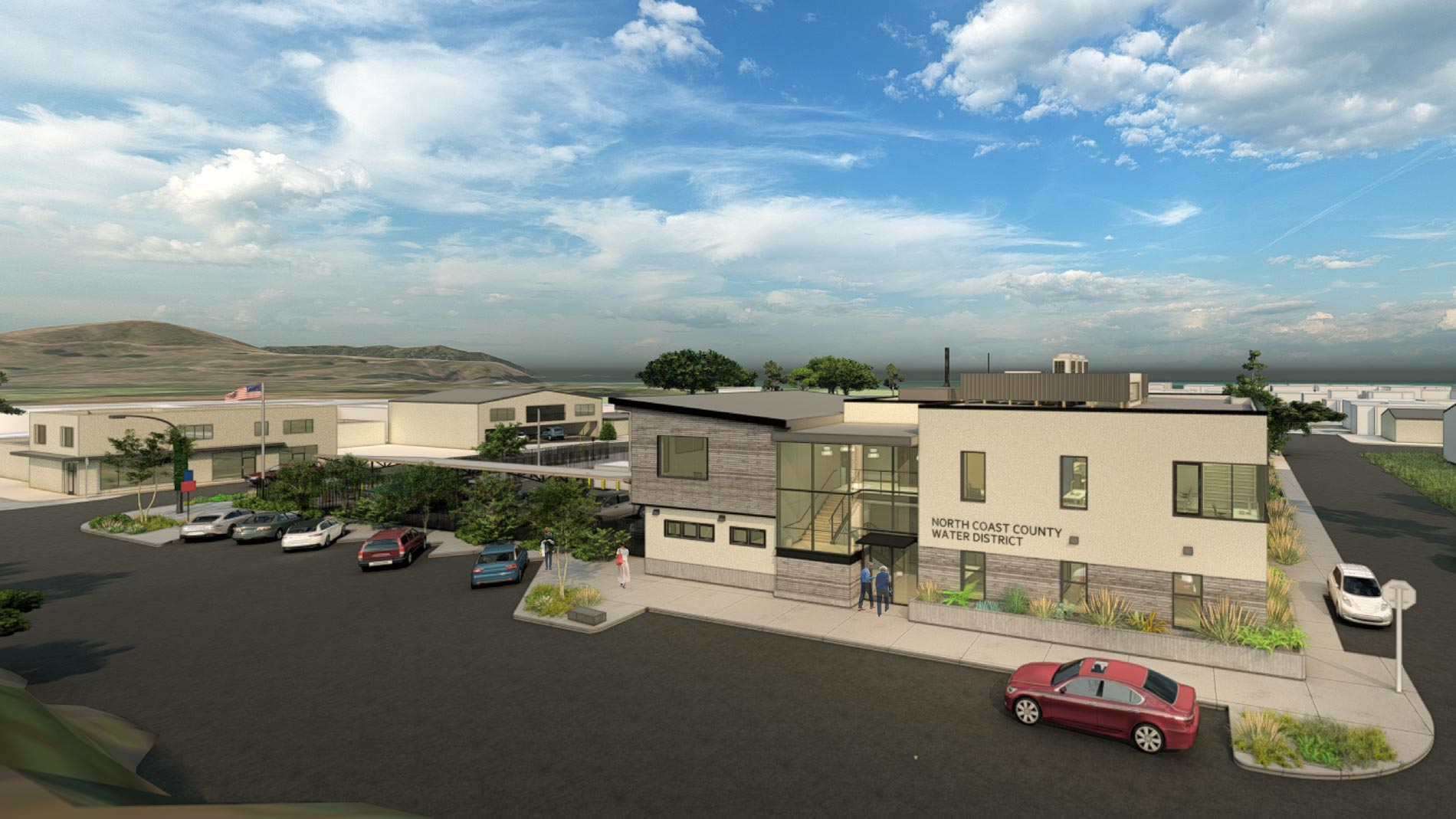 A modern building labeled "North Coast County Water District" with cars parked outside against a scenic backdrop.