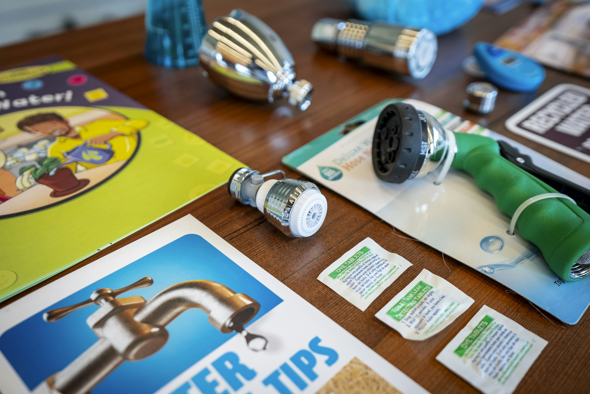 The image displays water-saving tools, tips, and educational materials, promoting efficient water use.