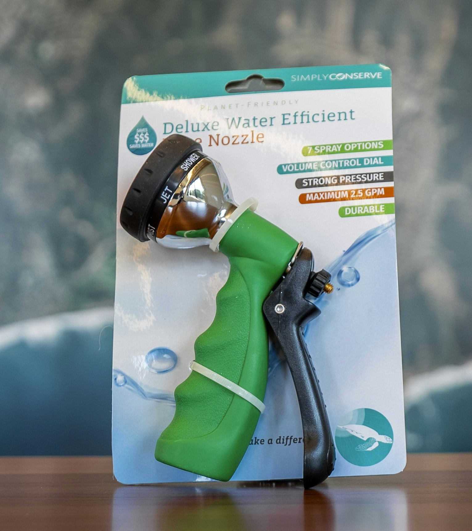 A green and silver water nozzle for efficient watering, featuring multiple spray options and a volume control dial.