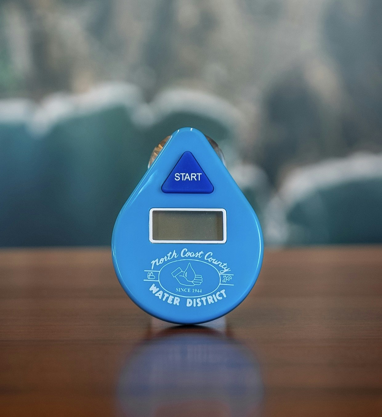 A blue water timer from North Coast County Water District, featuring a digital display and a "START" button.