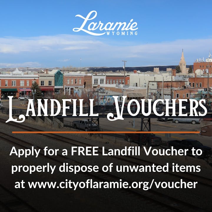 Ad for free landfill vouchers in Laramie, Wyoming with a town view in the background.