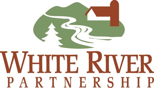 The image is a logo for "White River Partnership," featuring a river, a tree, and a house within a green landscape.